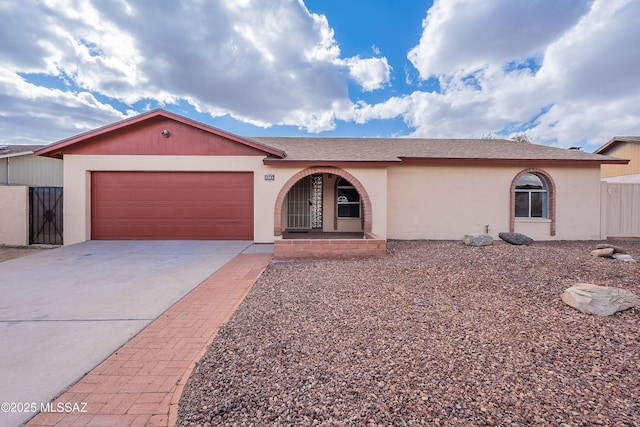 single story home featuring concrete driveway, a garage, and stucco siding