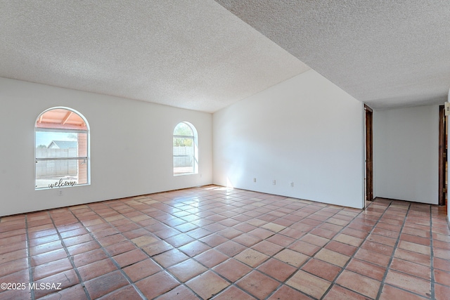 unfurnished room featuring light tile patterned floors and a textured ceiling