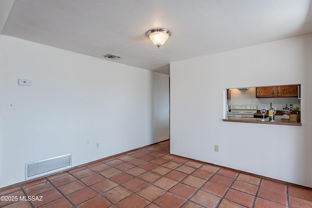 tiled spare room with visible vents