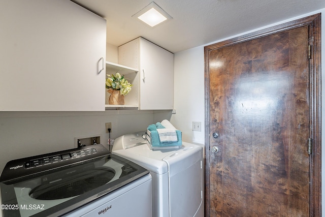 washroom with washer and dryer and cabinet space