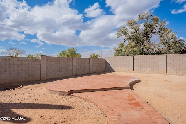 view of yard featuring a patio and a fenced backyard