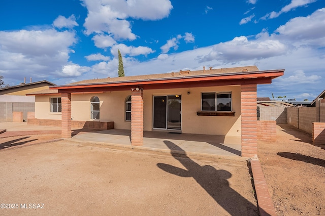 back of property with a patio area, stucco siding, and a fenced backyard