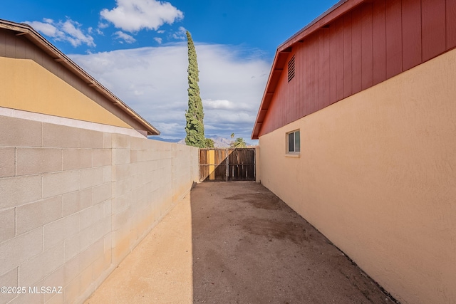 view of side of home with a patio and fence