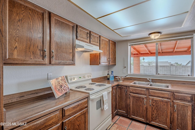 kitchen with white range with electric stovetop, under cabinet range hood, and a sink