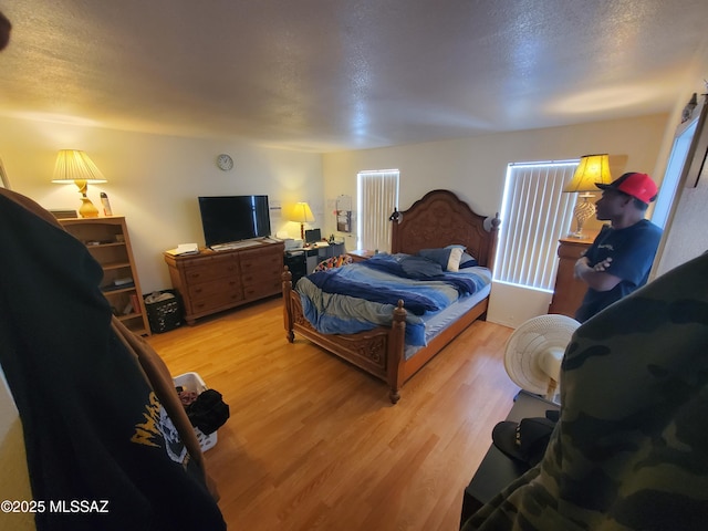 bedroom featuring a textured ceiling and light wood-type flooring