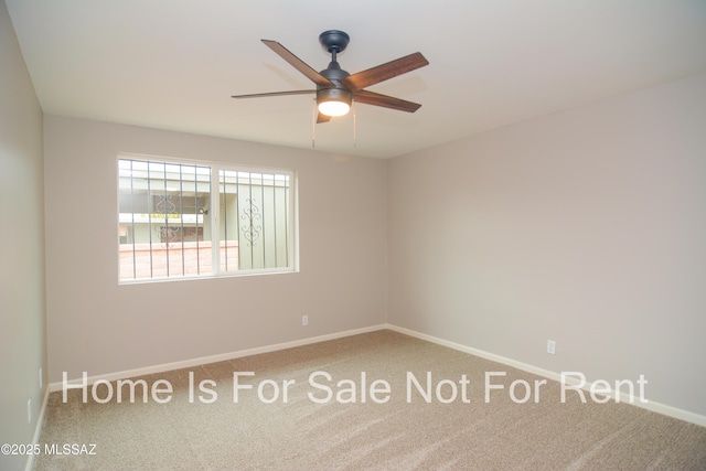 empty room featuring baseboards, a ceiling fan, and carpet flooring