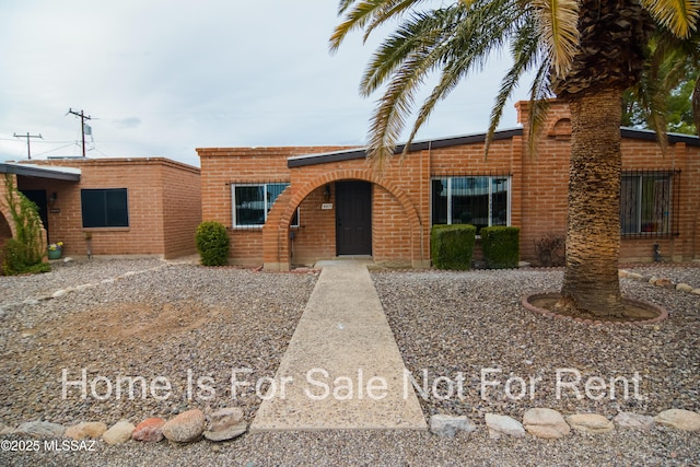 view of front of home featuring brick siding