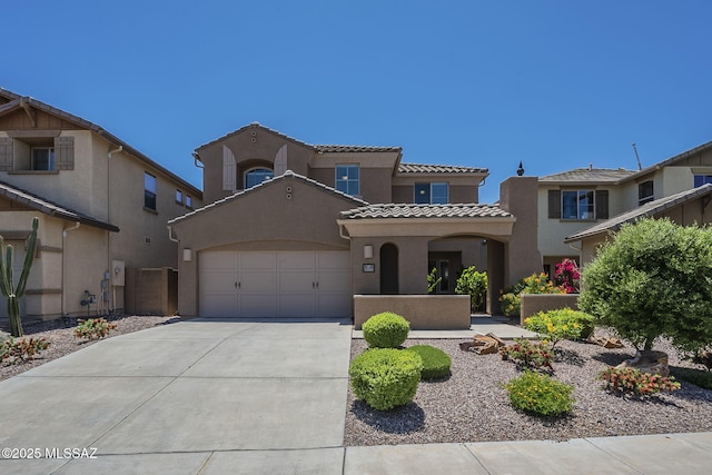 mediterranean / spanish-style home featuring an attached garage, stucco siding, driveway, and a tile roof