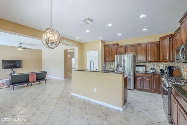 kitchen with stainless steel appliances, open floor plan, decorative backsplash, light tile patterned floors, and visible vents
