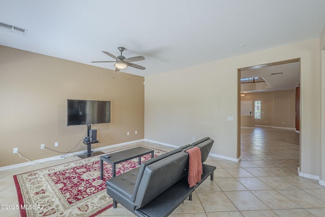living area featuring visible vents, a ceiling fan, baseboards, and light tile patterned floors