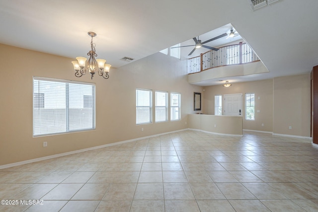 unfurnished room featuring baseboards, ceiling fan with notable chandelier, light tile patterned flooring, and visible vents