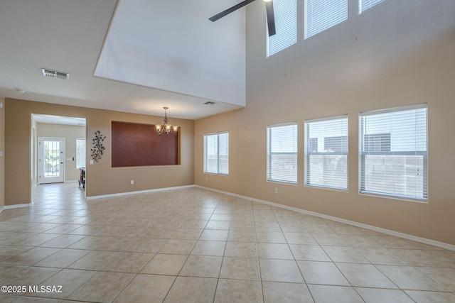 unfurnished room with visible vents, baseboards, plenty of natural light, and light tile patterned floors