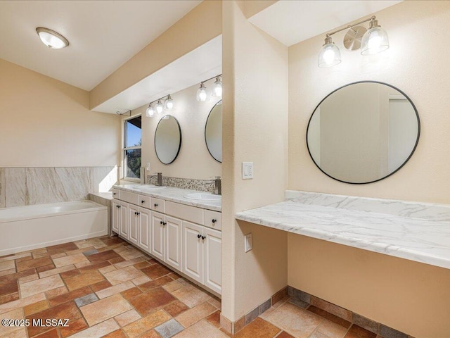 bathroom with double vanity, stone tile flooring, and a sink