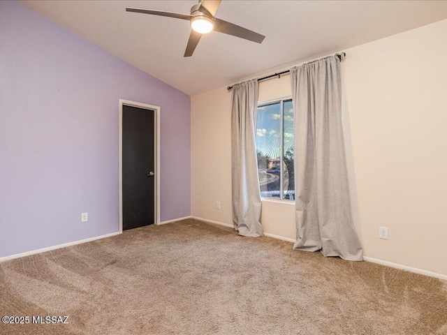 spare room with baseboards, ceiling fan, carpet flooring, and vaulted ceiling