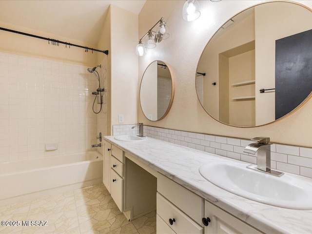 bathroom featuring a sink, tasteful backsplash, double vanity, and shower / bathtub combination