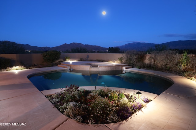 view of pool with an in ground hot tub, a fenced in pool, fence, and a mountain view