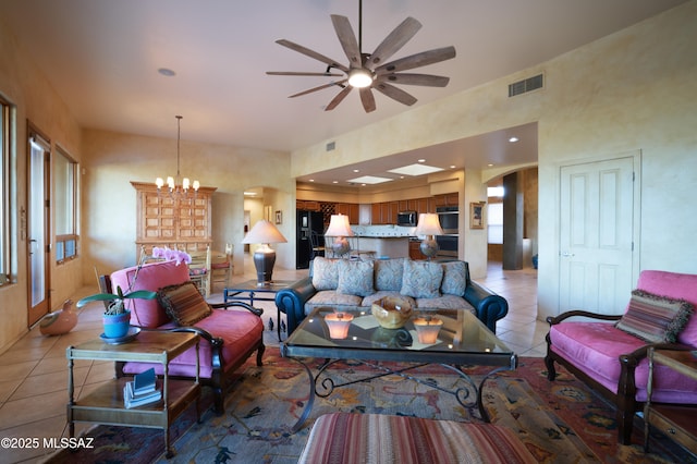 living room featuring visible vents, light tile patterned floors, ceiling fan with notable chandelier, recessed lighting, and arched walkways