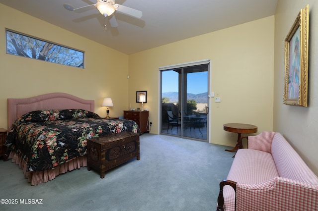 carpeted bedroom with a mountain view, ceiling fan, and access to outside