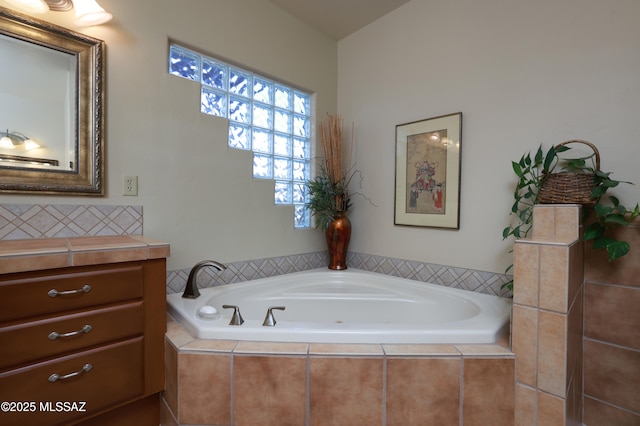 full bathroom featuring a bath and vanity