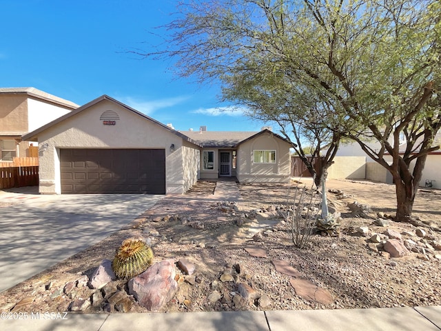 single story home with concrete driveway, fence, a garage, and stucco siding