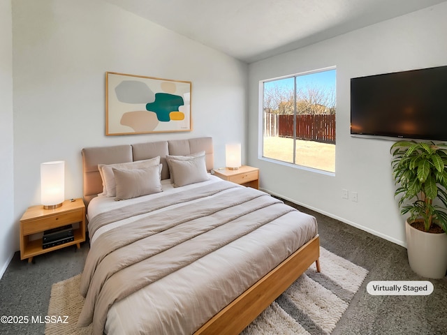 bedroom featuring lofted ceiling, carpet, and baseboards