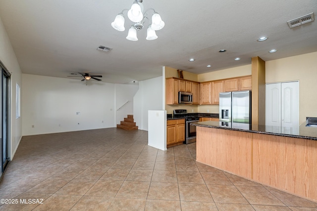 kitchen featuring stainless steel appliances, open floor plan, visible vents, and light tile patterned flooring