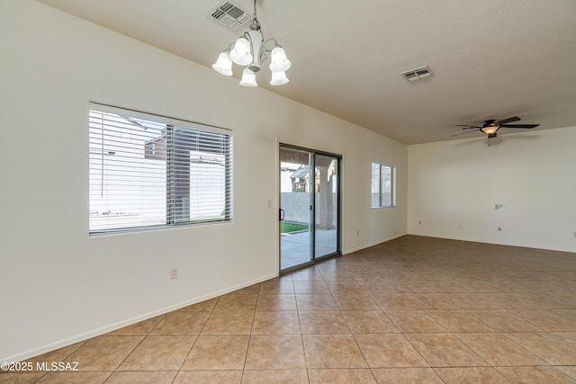 empty room featuring light tile patterned floors, visible vents, and plenty of natural light