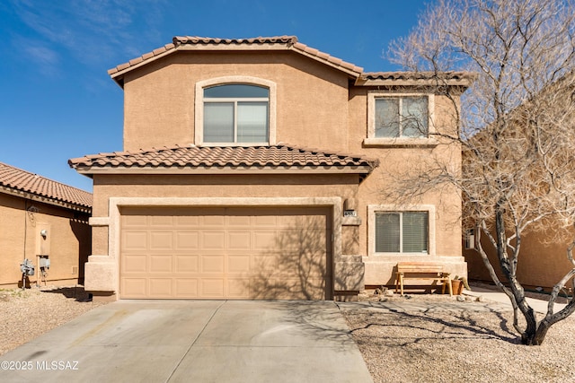 mediterranean / spanish home with a garage, a tile roof, concrete driveway, and stucco siding