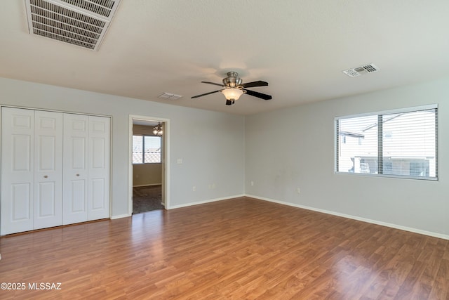 unfurnished bedroom featuring baseboards, visible vents, and light wood-type flooring