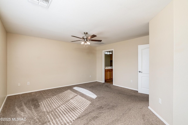 carpeted empty room featuring visible vents, baseboards, and ceiling fan