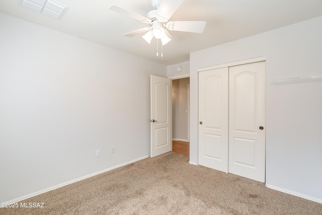 unfurnished bedroom with visible vents, a ceiling fan, a closet, carpet, and baseboards