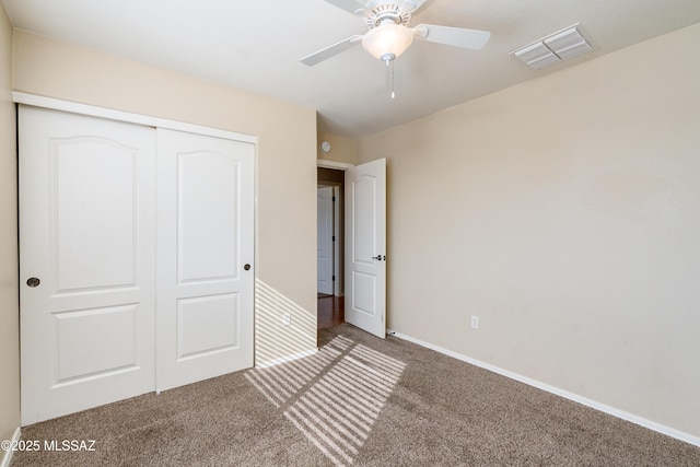 unfurnished bedroom with visible vents, ceiling fan, baseboards, carpet flooring, and a closet