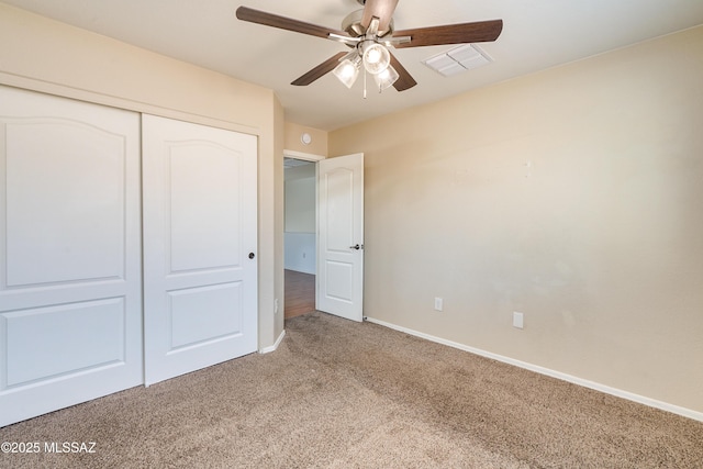 unfurnished bedroom with a ceiling fan, visible vents, baseboards, a closet, and light colored carpet