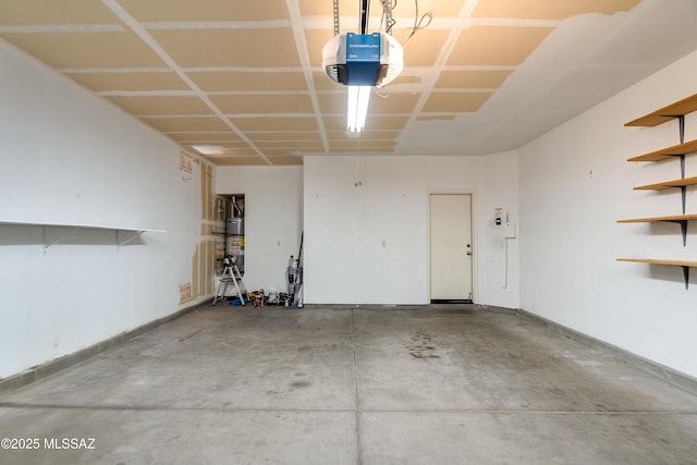 garage featuring baseboards and a garage door opener