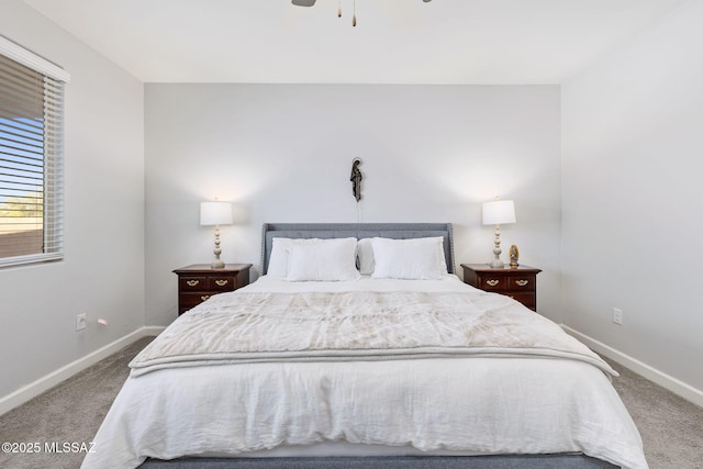 carpeted bedroom with ceiling fan and baseboards