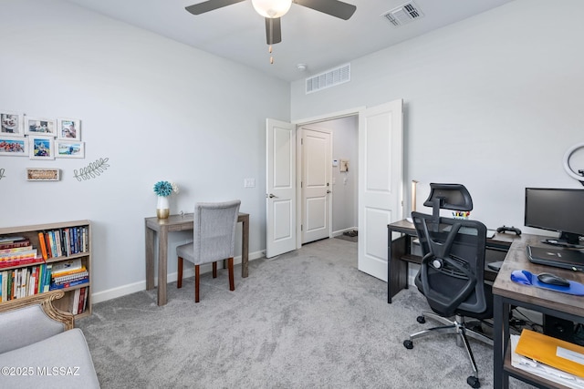 carpeted home office with baseboards, visible vents, and ceiling fan