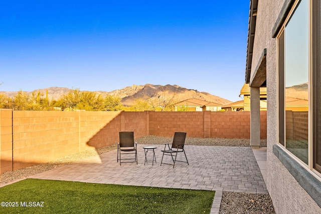 view of patio with a fenced backyard and a mountain view