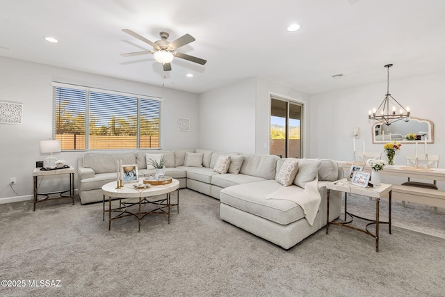 living room with ceiling fan with notable chandelier, recessed lighting, and a wealth of natural light