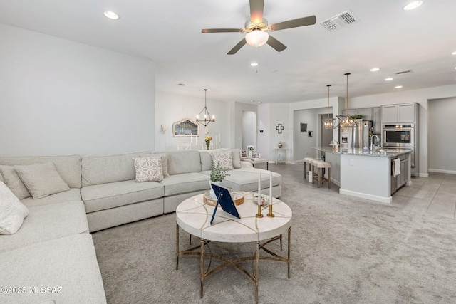 living area with visible vents, baseboards, ceiling fan, light colored carpet, and recessed lighting