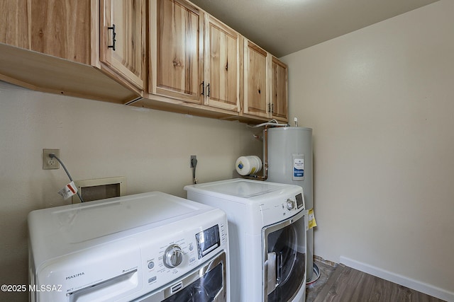 washroom with water heater, dark wood finished floors, baseboards, independent washer and dryer, and cabinet space