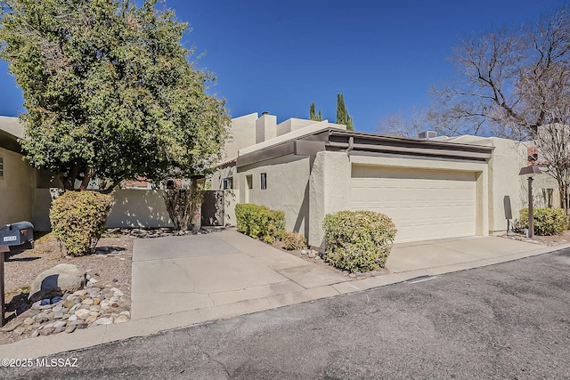 view of side of property with stucco siding and a garage