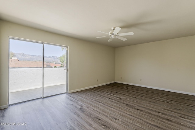 unfurnished room featuring a ceiling fan, baseboards, and wood finished floors