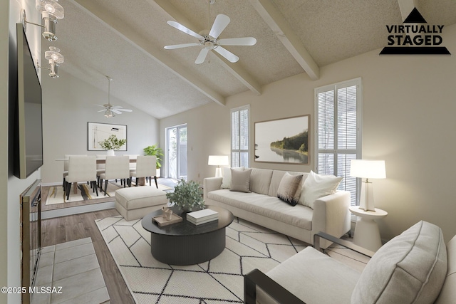 living room with wood finished floors, lofted ceiling with beams, a textured ceiling, and ceiling fan
