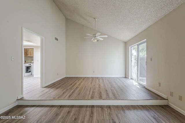 unfurnished room featuring a ceiling fan, wood finished floors, a textured ceiling, washer / dryer, and baseboards
