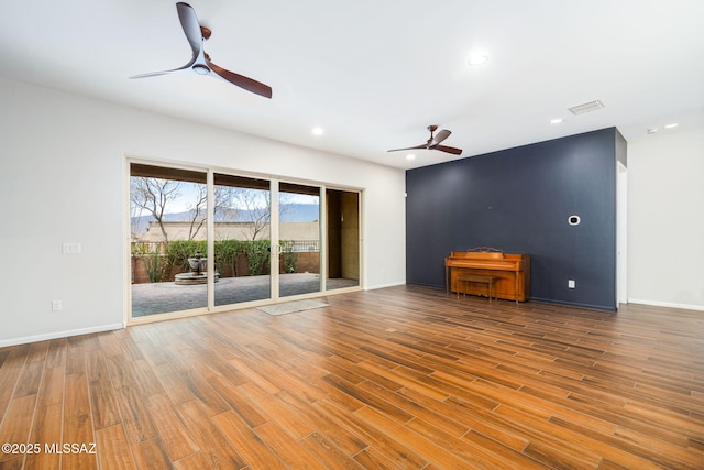 unfurnished living room with a ceiling fan, visible vents, wood finished floors, and recessed lighting