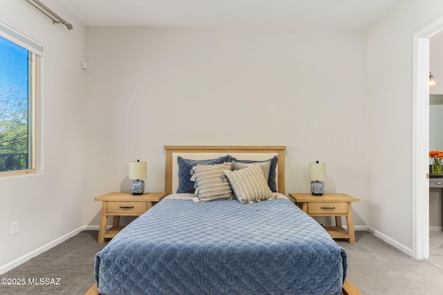 carpeted bedroom with baseboards and multiple windows