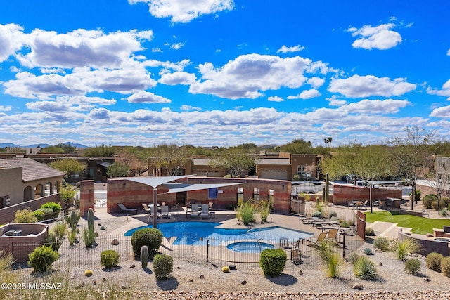 pool featuring a hot tub, a patio, and fence