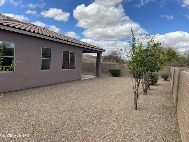 view of yard featuring a patio area and a fenced backyard