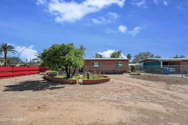 view of front of house with brick siding and fence