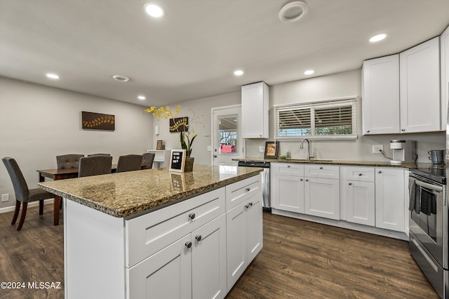 kitchen featuring dark stone countertops, appliances with stainless steel finishes, recessed lighting, and dark wood-style flooring